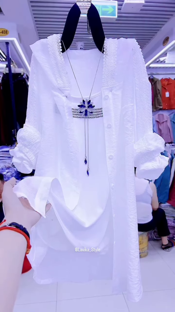 Elegant White Layered Outfit with Striking Blue Necklace - Photo 1