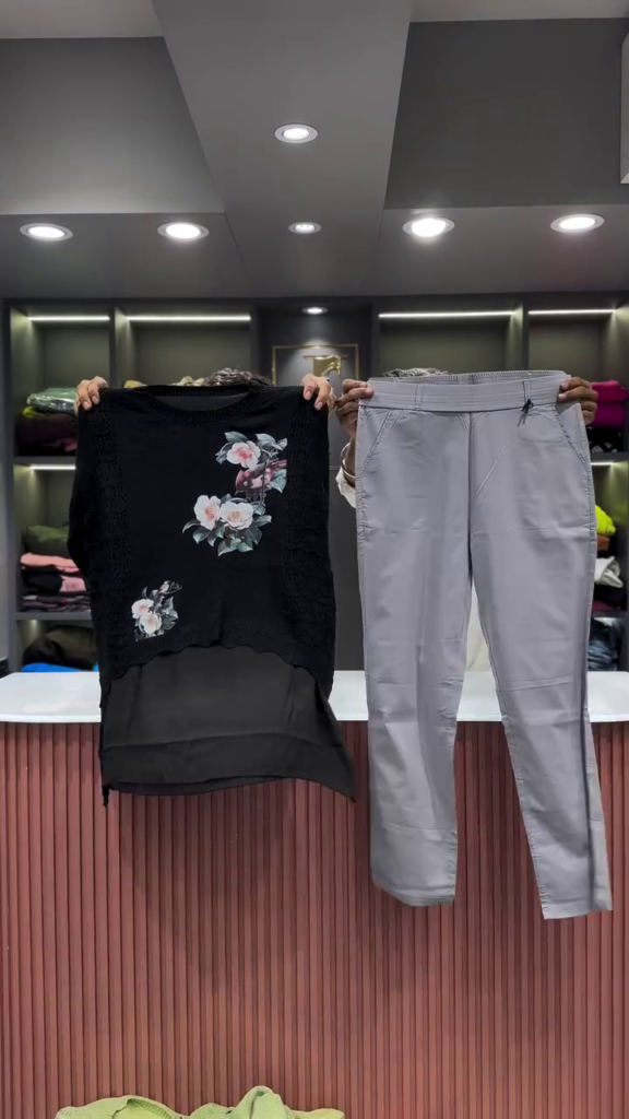 Black Open-Knit Top with Floral Appliqués and Gray Pants - Photo 1